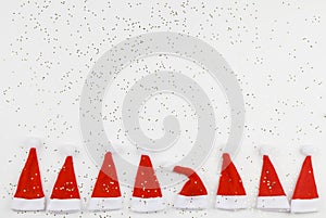 Santa Claus hats on white background with little stars. Christmas and New Year celebration. Christmas concept