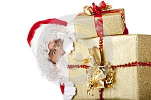 Santa Claus is hiding behind Christmas gift boxes