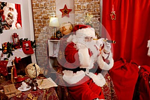 Santa Claus at his home, holding spyglass, preparing for travel