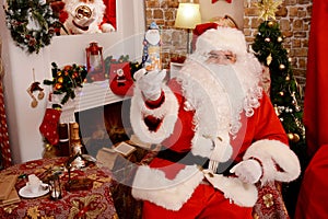 Santa Claus holding Christmas figurine