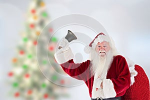 Santa claus holding gift sack and ringing bell