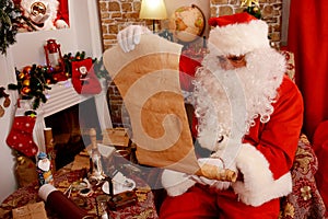 Santa Claus holding old scroll of parchment,
