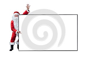 Santa Claus is holding and pointing the white blank sign for seasonal promotion sale and announcement board advertisement isolated