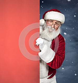 Santa Claus holding red blank sign, Christmas advertising