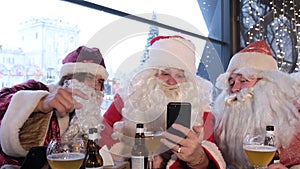 Santa Claus holding a smart phone with a Christmas massage, using a mobile application