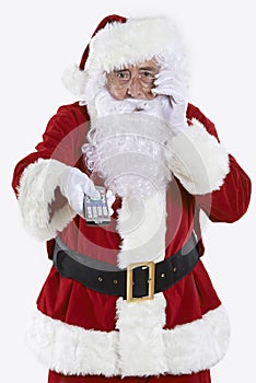 Santa Claus Holding Television Remote Control