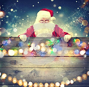 Santa Claus holding wooden banner background
