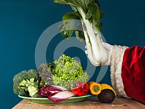 Santa Claus holds fresh bok choy in his hand. Healthy lifestyle en new year\'s resolutions concept