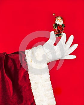 Santa Claus holds in his hand a souvenir. Giving a gift concept
