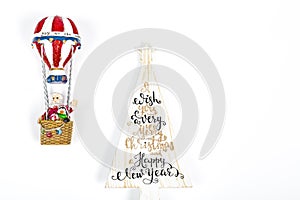 Santa Claus in Hot air balloon flight up to a wood white tree, on white background