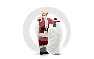 Santa Claus with the huge antiseptics against COVID like Christmas gift isolated on white background