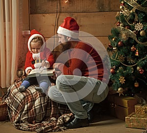 Santa claus kid and bearded man at Christmas tree.