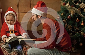 Santa claus kid and bearded man at Christmas tree.