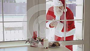 Santa Claus knocking in window and want to taste milk and cookies