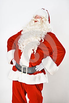 Santa claus, laugh and in studio for Christmas holiday, festive season or celebration joy. Male person, red outfit and