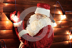 Santa Claus lights the lights on the Christmas tree