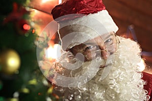 Santa Claus lights the lights on the Christmas tree