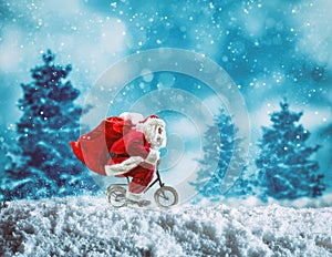 Santa Claus on a little bike on a winter landscape under the snow