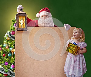 Santa Claus with a little girl, vintage lantern and a poster