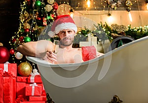 Santa Claus luxuriate in warm bath. Take delight. Pampering myself. Winter holidays. New year. Mature man lying in