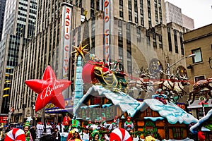 Santa Claus during the Macy`s Thanksgiving Day parade along Avenue of Americas with the Radio Music Hall in the background.