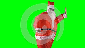 Santa Claus makes dancing moves with arms and legs on a green background.