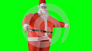 Santa Claus makes robot moves with his hands on green background.