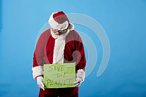 Santa Claus making gestures for a poster on a blue background