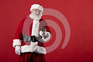 Santa Claus making gestures for a poster on a red background