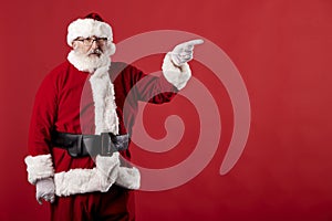 Santa Claus making gestures for a poster on a red background