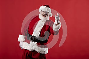 Santa Claus making gestures for a poster on a red background