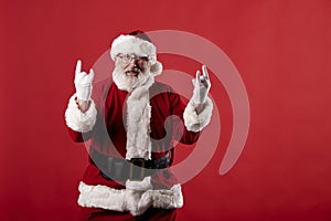 Santa Claus making gestures for a poster on a red background