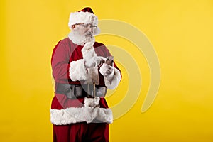 Santa Claus making gestures for a poster on a yellow background