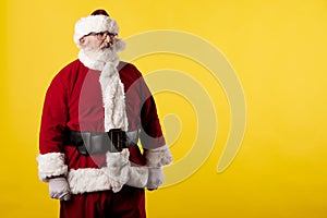 Santa Claus making gestures for a poster on a yellow background