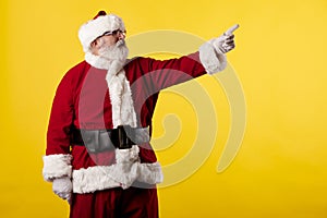 Santa Claus making gestures for a poster on a yellow background