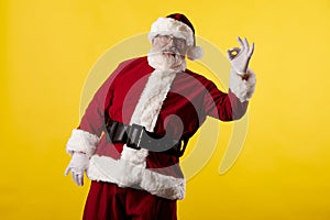 Santa Claus making gestures for a poster on a yellow background