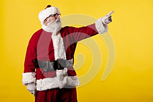 Santa Claus making gestures for a poster on a yellow background