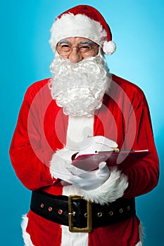 Santa Claus making his list of the good children