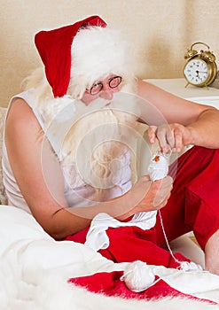 Santa Claus mending his socks photo