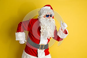 Santa Claus with modern eyeglasses isolated on yellow studio background