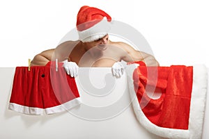 Santa Claus muscular hung his clothes on a banner sales