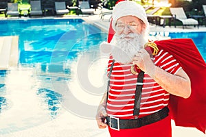 Santa Claus near the pool holiday vacation concept