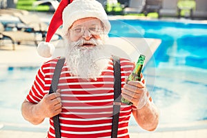 Santa Claus near the pool holiday vacation concept