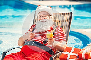 Santa Claus near the pool holiday vacation concept