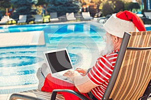 Santa Claus near the pool holiday vacation concept photo