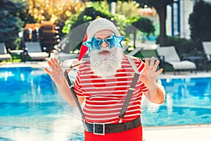 Santa Claus near the pool holiday vacation concept