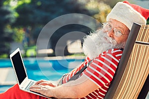 Santa Claus near the pool holiday vacation concept