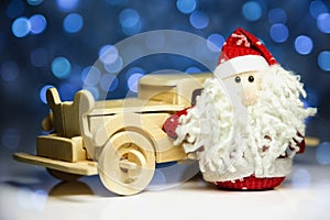 Santa Claus with old retro wooden car