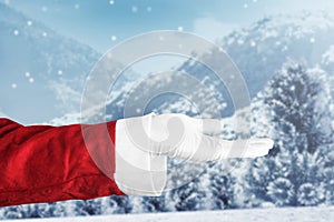 Santa Claus with an open hand gesture with snowfall background