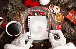 Santa Claus with open notepad